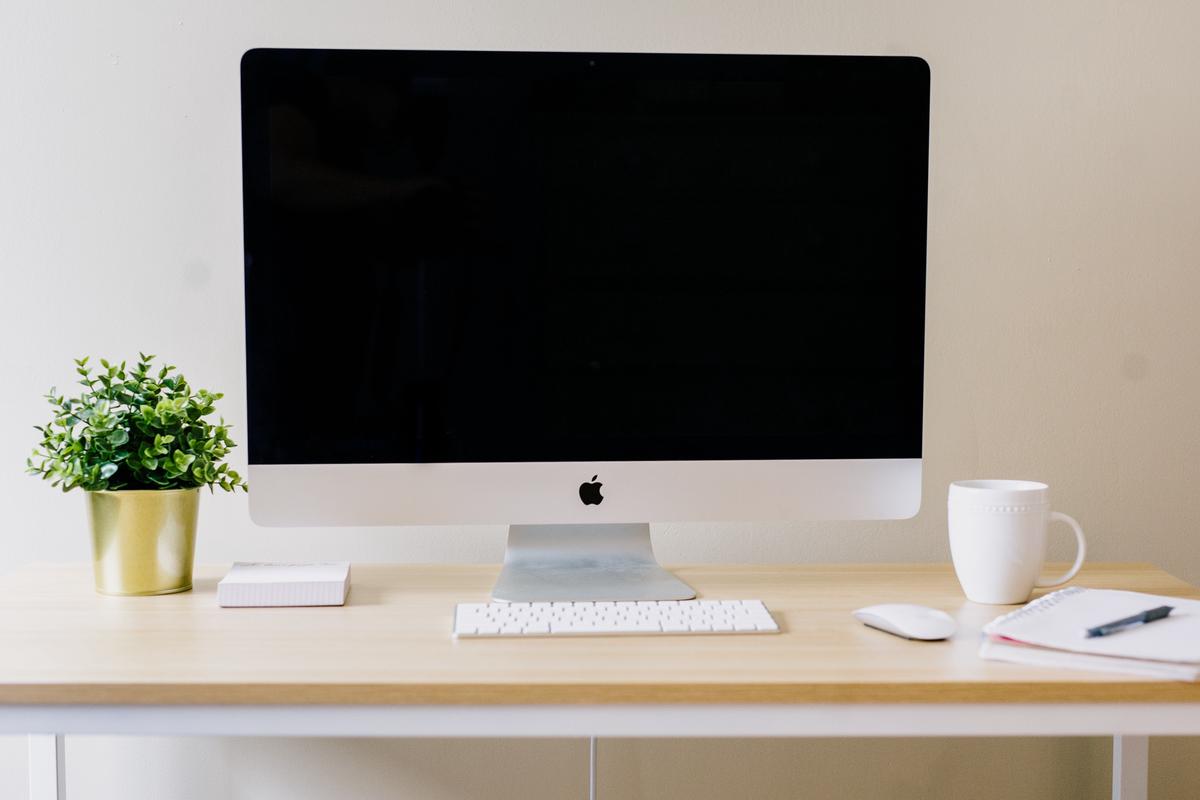 A computer monitor with multiple devices connected to it, representing the concept of MDM solution for managing devices.